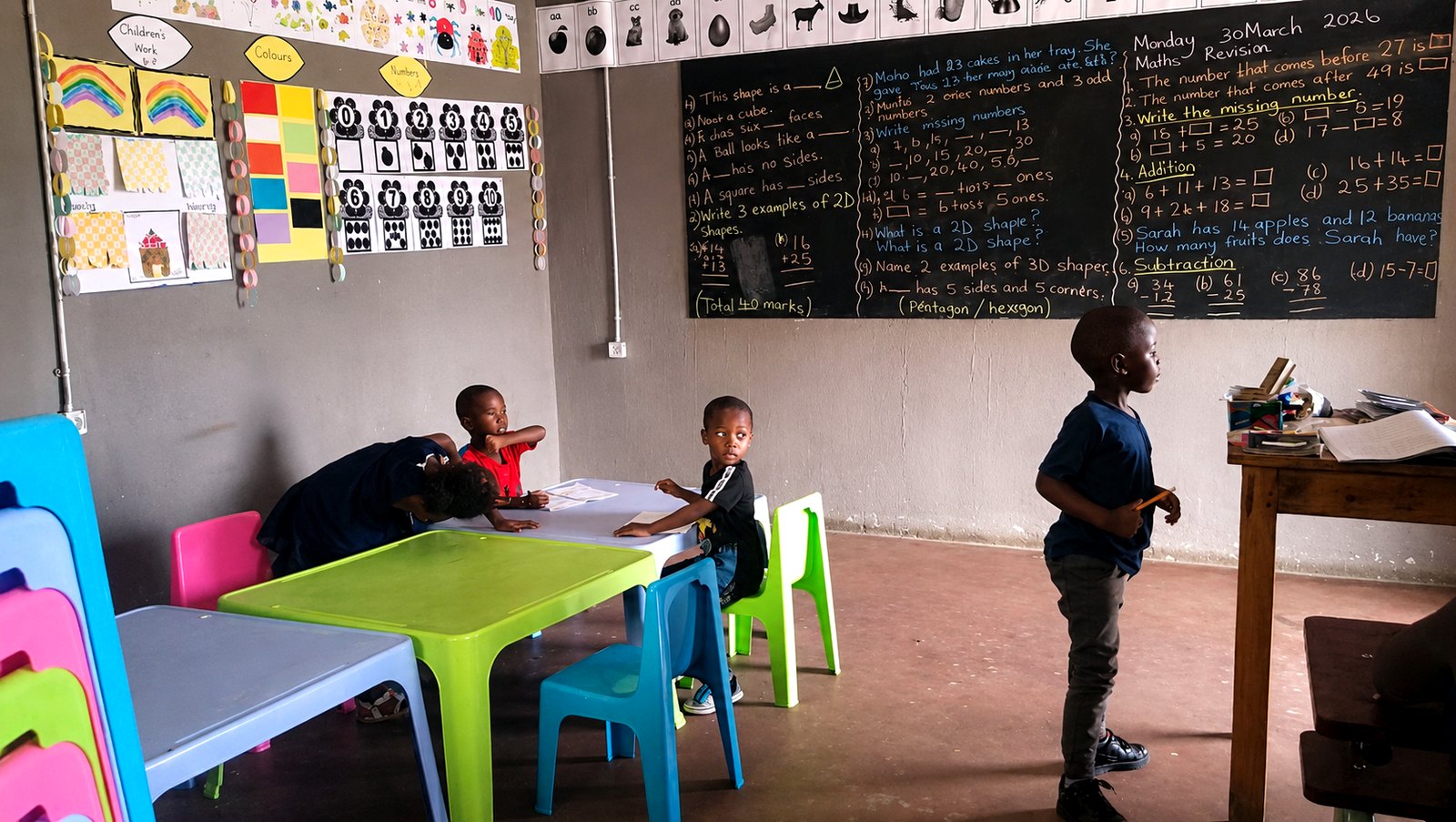 Young learners at colorful tables during a maths revision lesson