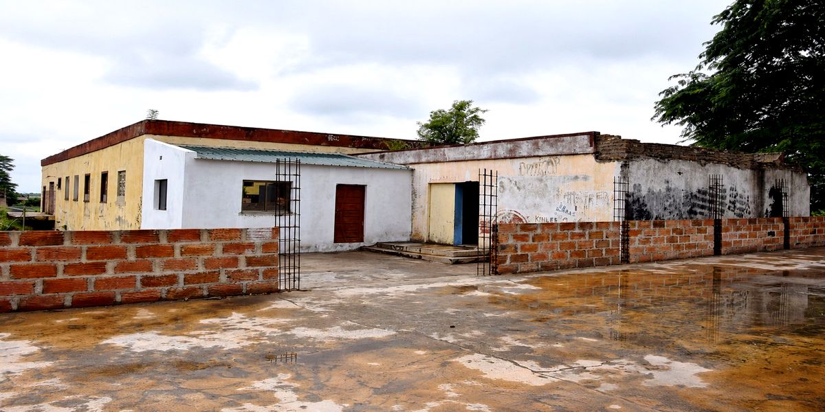 The school courtyard with completed perimeter walls and new classroom blocks